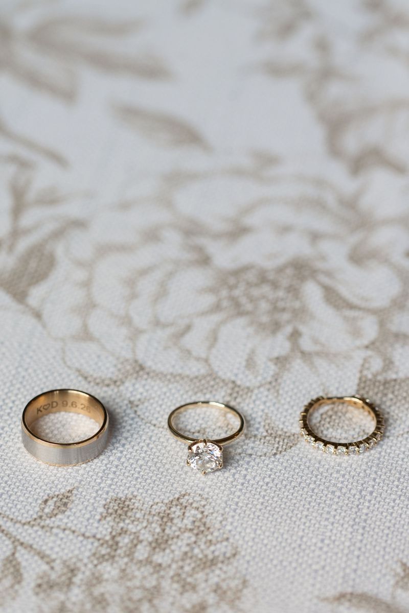 Three gold wedding rings resting on lace
