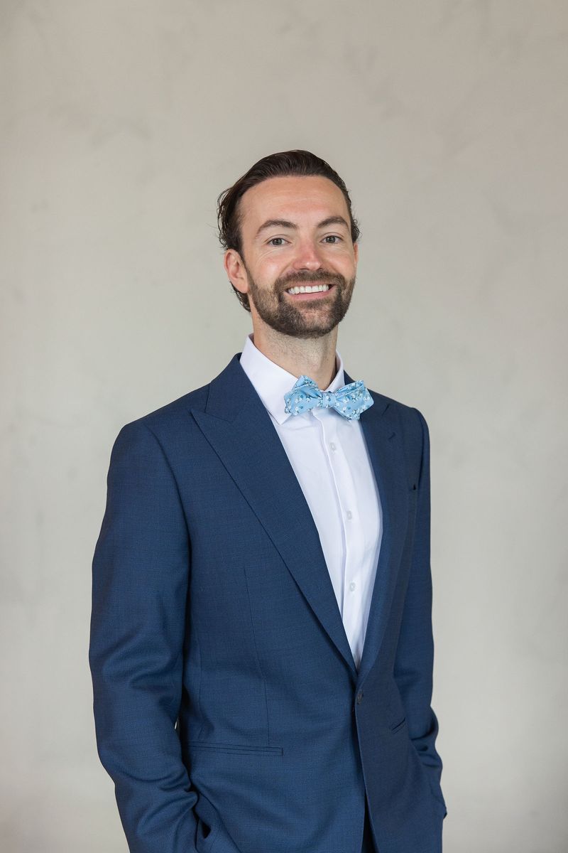 Dennis in his navy suit and light-blue bow tie on the wedding day