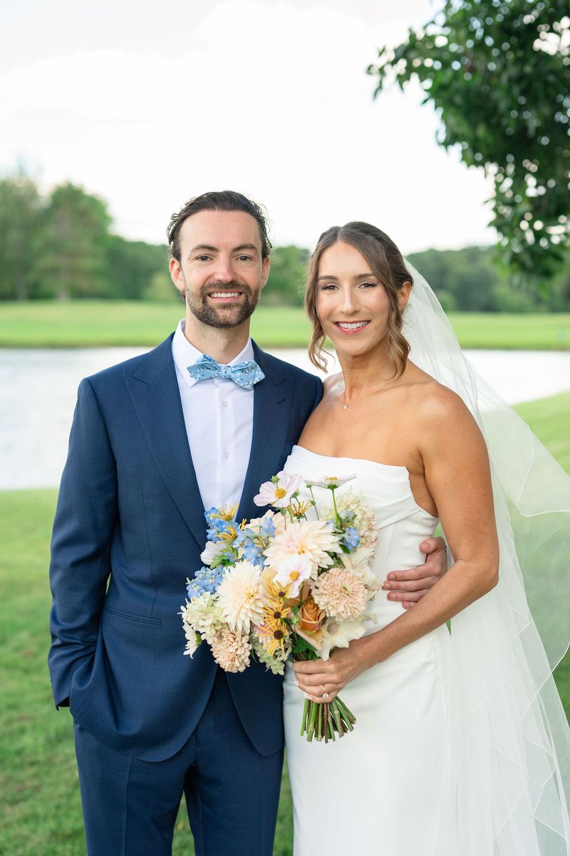 Katie and Dennis with her bouquet on the lawn
