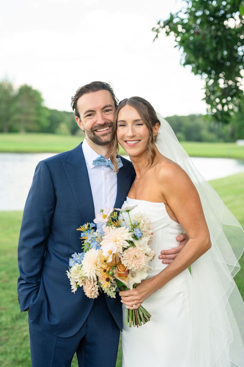 Katie and Dennis smiling on the lawn