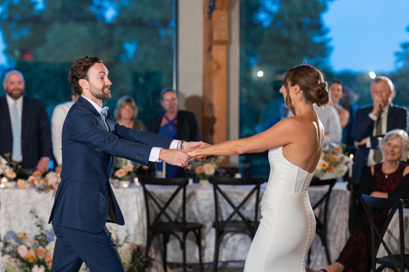 Katie and Dennis's first dance, with family watching from the head table