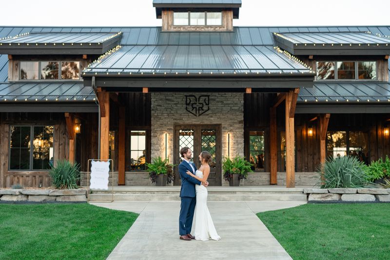 Katie and Dennis on the path in front of the Revel Run clubhouse at dusk