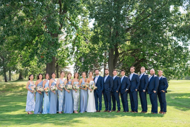 Katie and Dennis with their wedding party in blue under the oaks at Revel Run