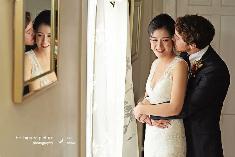Brian kissing Yu-ju's cheek beside a mirror