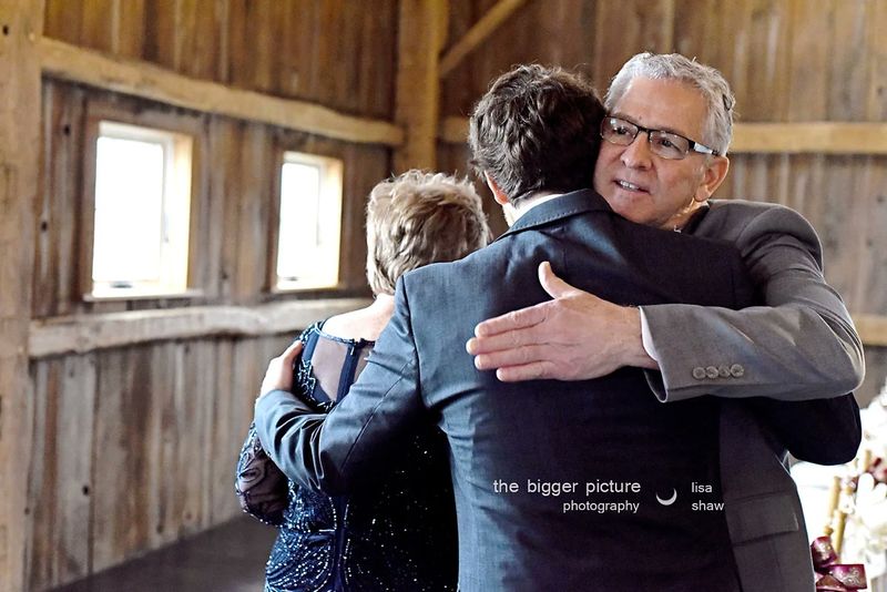 Brian hugging his father in the barn