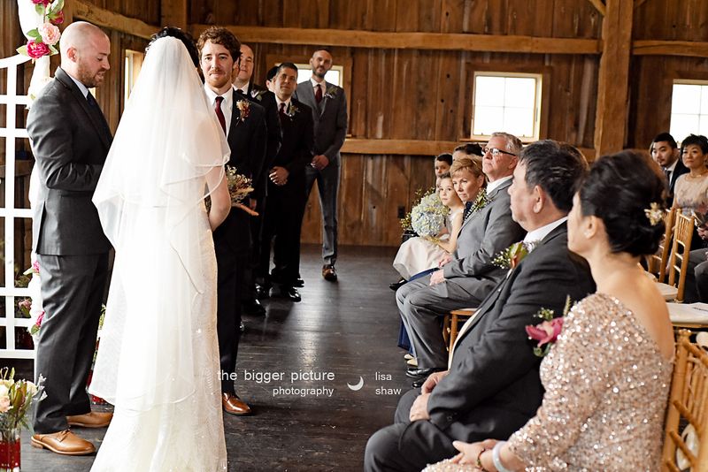 Yu-ju and Brian at the front of the barn, guests watching