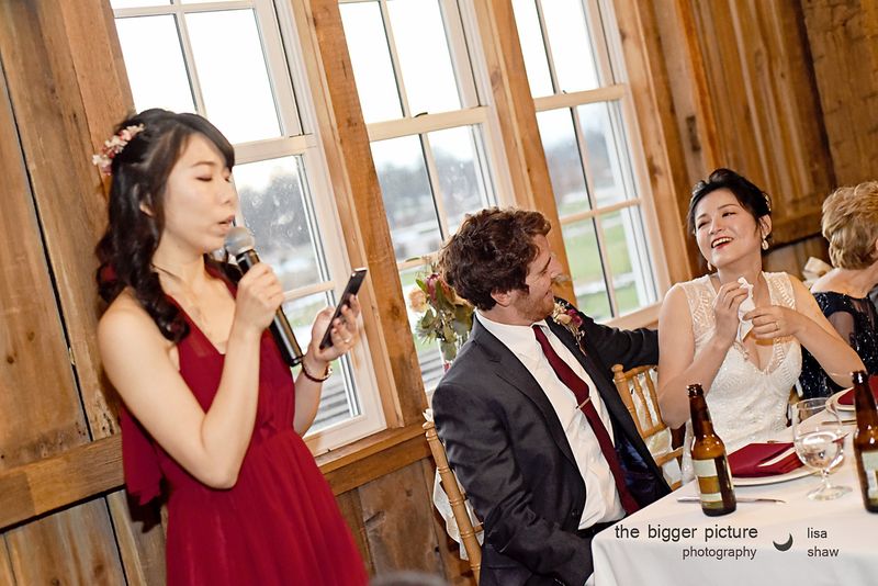 A bridesmaid giving a toast at the microphone