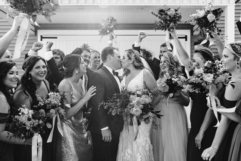 The wedding party cheering, in black and white