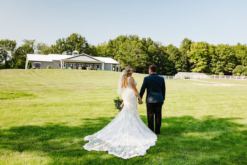 Genna and Frank walking across the lawn toward The Oakley