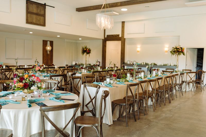 The reception hall set with teal linens