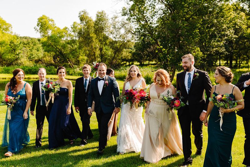 The wedding party walking across the lawn
