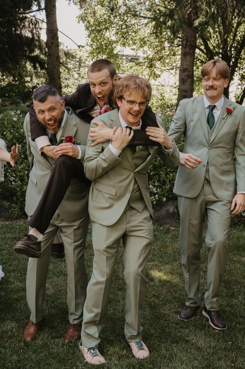 The groomsmen fooling around on the lawn