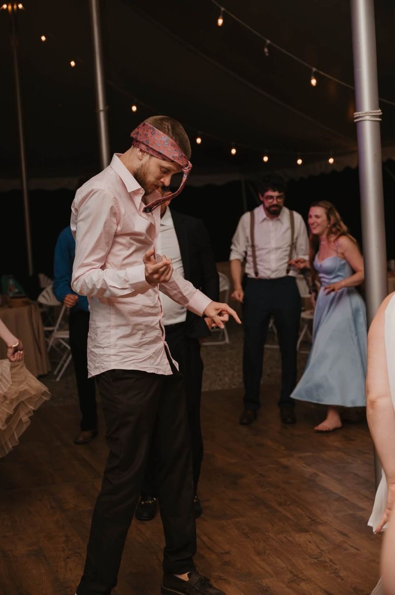 A guest dancing with a tie around his head