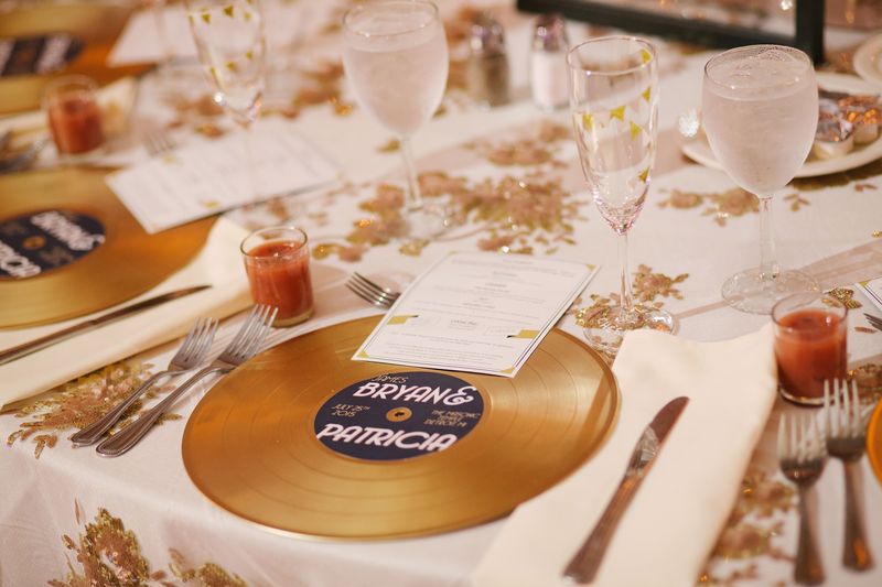 A place setting with a gold record charger printed with their names