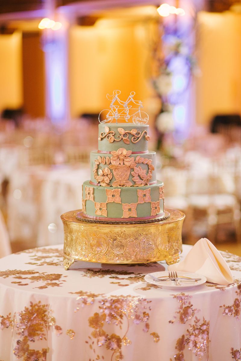 The wedding cake in mint and peach on a gold stand