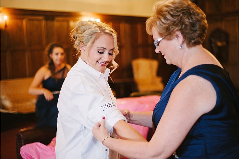 Patricia's mother helping her into her dress