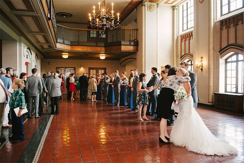 Guests lining a long hall to greet the couple