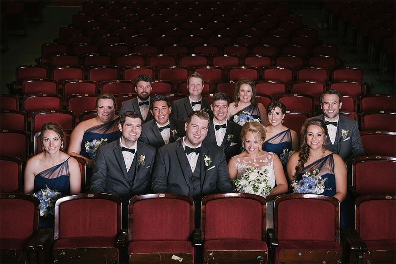 The wedding party in the red seats of the Masonic Temple theatre