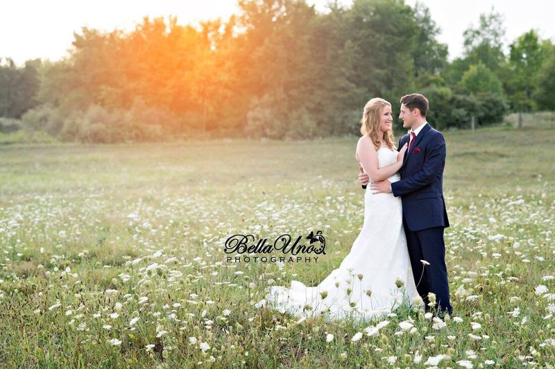 Tom and Ellen in a field of wildflowers at The Oakley at sunset
